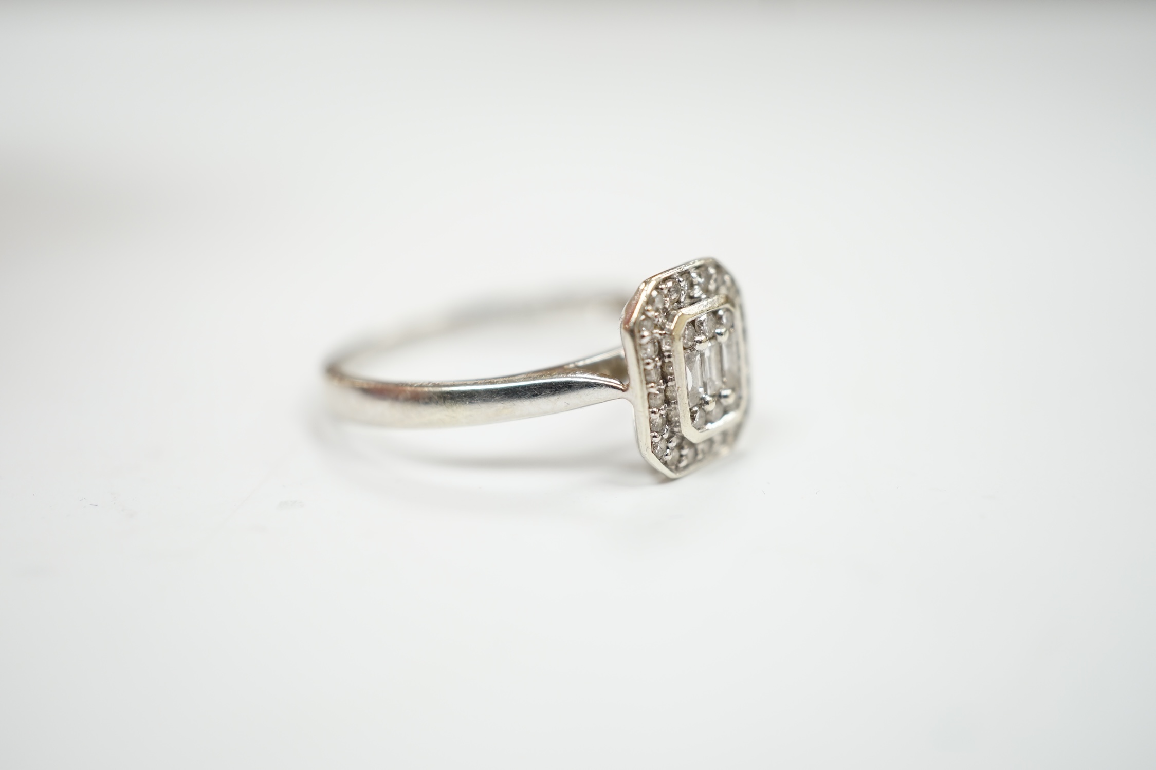 A modern 9ct white gold and diamond set cluster ring, size N, gross weight 2.5 grams.